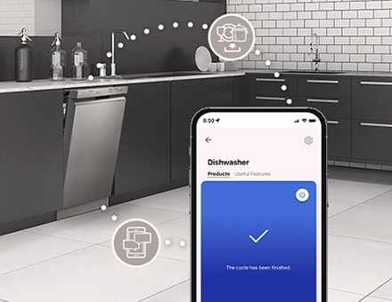 A modern kitchen with a stainless steel dishwasher connected to a smartphone showing the finished cycle notification.